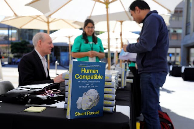 Russell signing copies of his book &apos;Human Compatible: Artificial Intelligence and the Problem of Control&apos; at the TechCrunch event. Source: TechCrunch