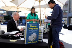 Russell signing copies of his book 'Human Compatible: Artificial Intelligence and the Problem of Control' at the TechCrunch event. Source: TechCrunch Russell signing copies of his book 'Human Compatible: Artificial Intelligence and the Problem of Control' at the TechCrunch event. Source: TechCrunch