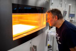 Dave Jacek, additive manufacturing technician, oversees production of 3D-printed disposable respirator mask prototypes at Ford's Advanced Manufacturing Center. Dave Jacek, additive manufacturing technician, oversees production of 3D-printed disposable respirator mask prototypes at Ford's Advanced Manufacturing Center.