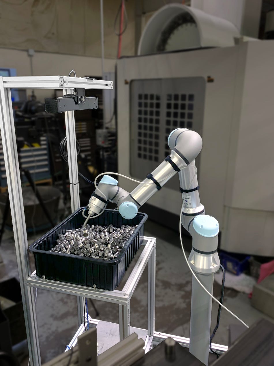ActiNav combines a UR e-Series cobot with a 3D sensor and real-time autonomous motion control to enable picking from a bin for precise part placement in a machine.