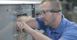 Worker using Honeywell Intelligrated's TechSight to receive guided maintenance assistance. Worker using Honeywell Intelligrated's TechSight to receive guided maintenance assistance.