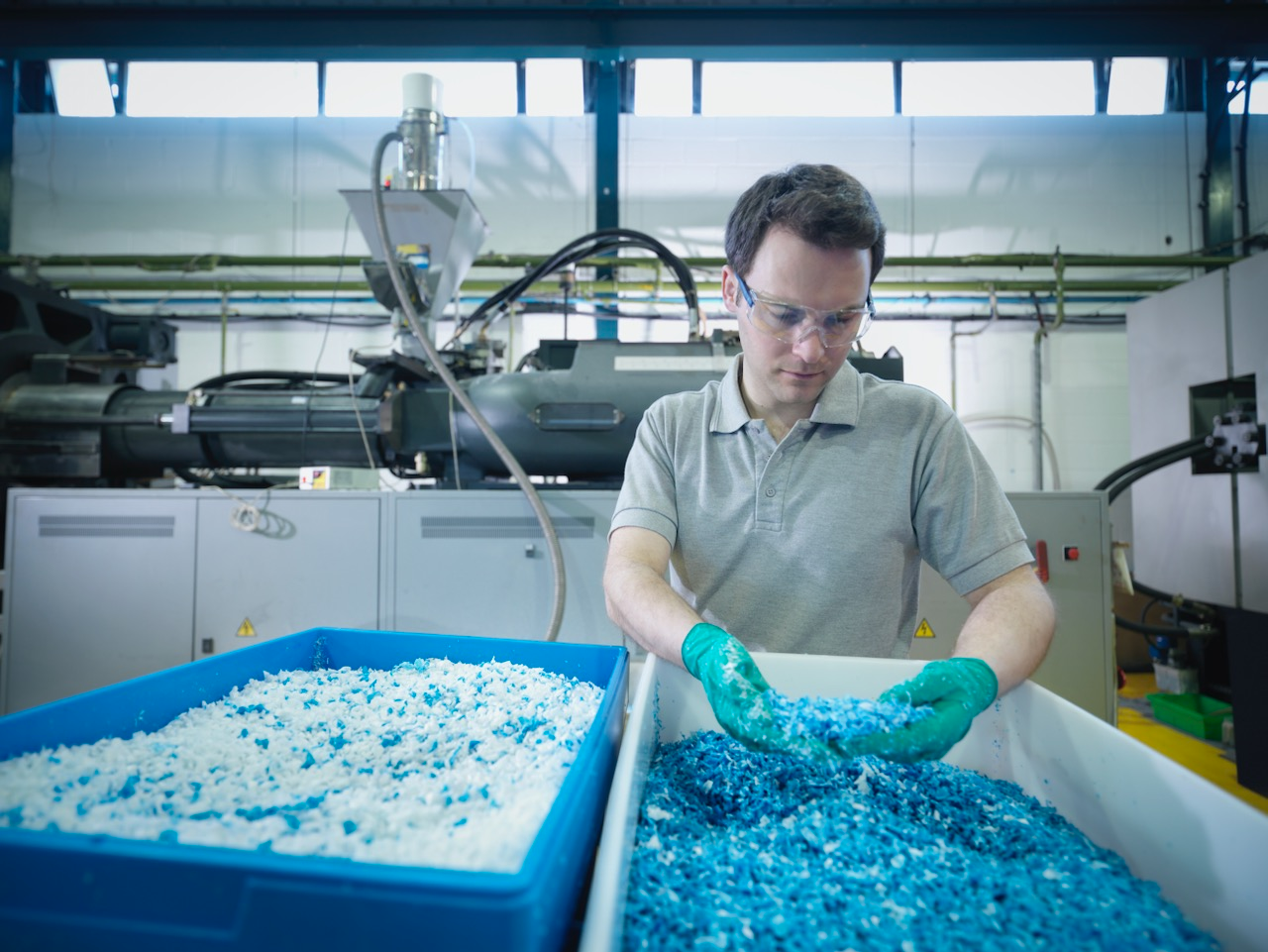 Worker inspecting recycled plastic in plastics factory. Source: Getty Images