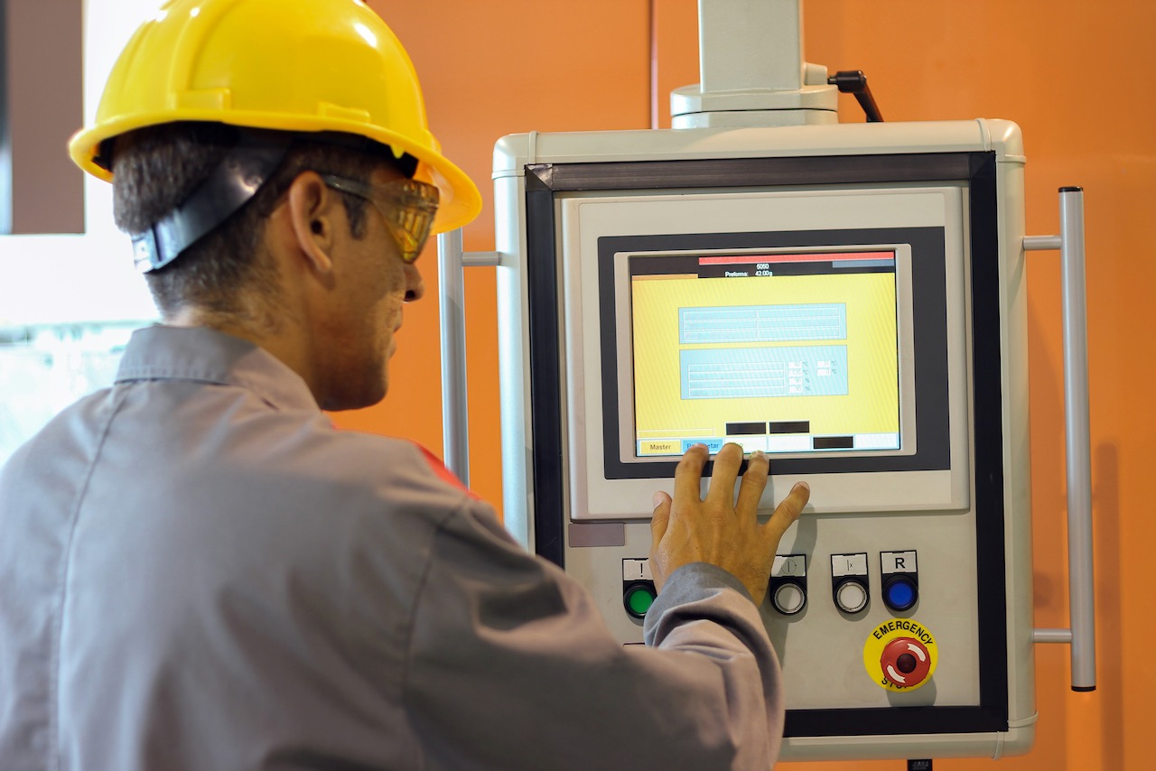 Plant floor worker accessing HMI system. Source: Elatec Inc.