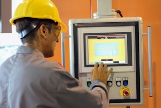 Plant floor worker accessing HMI system. Source: Elatec Inc.