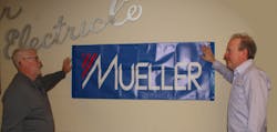 Eddie Williams, General Manager from Elcor (left), and Cliff Prosek, President from Mueller Electric, discuss details of the company merger. Eddie Williams, General Manager from Elcor (left), and Cliff Prosek, President from Mueller Electric, discuss details of the company merger.