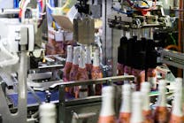 Smooth handling of bottles and partitions at Chandon is a hallmark of the end-of-line Wrap-Around case packer.