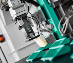 The 3D-printed gripper attached to the robot arm is designed to remove specially designed injection molded parts. Source: Arburg The 3D-printed gripper attached to the robot arm is designed to remove specially designed injection molded parts. Source: Arburg