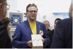Philip Harting, CEO of the HARTING Technology Group, used a model to present the functionality of the Han-Modular&circledR; Domino modules to the attending trade fair audience.