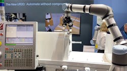 The Robotiq machine tending system using a Universal Robot cobot at IMTS 2022.
