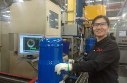 Danfoss's WuQing factory, whose waste heat recovery efforts are described in this article, has a zero-defects goal and uses advanced auto-visual monitoring of compressor parts to check for errors throughout the assembly process. In this photo: line operator Fenghuan Yan. Danfoss's WuQing factory, whose waste heat recovery efforts are described in this article, has a zero-defects goal and uses advanced auto-visual monitoring of compressor parts to check for errors throughout the assembly process. In this photo: line operator Fenghuan Yan.