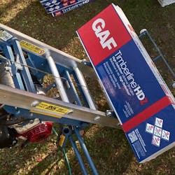 GAF's Timberline HDZ roofing shingles being moved to a roof for installation. GAF's Timberline HDZ roofing shingles being moved to a roof for installation.