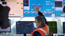 Veolia employee monitors screens in a project control center.