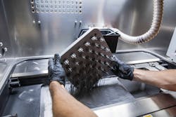 Removing a DMLS print from the powder. Removing a DMLS print from the powder.