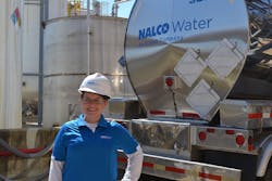 An associate of Nalco Water, an Ecolab company, working at a customer plant.