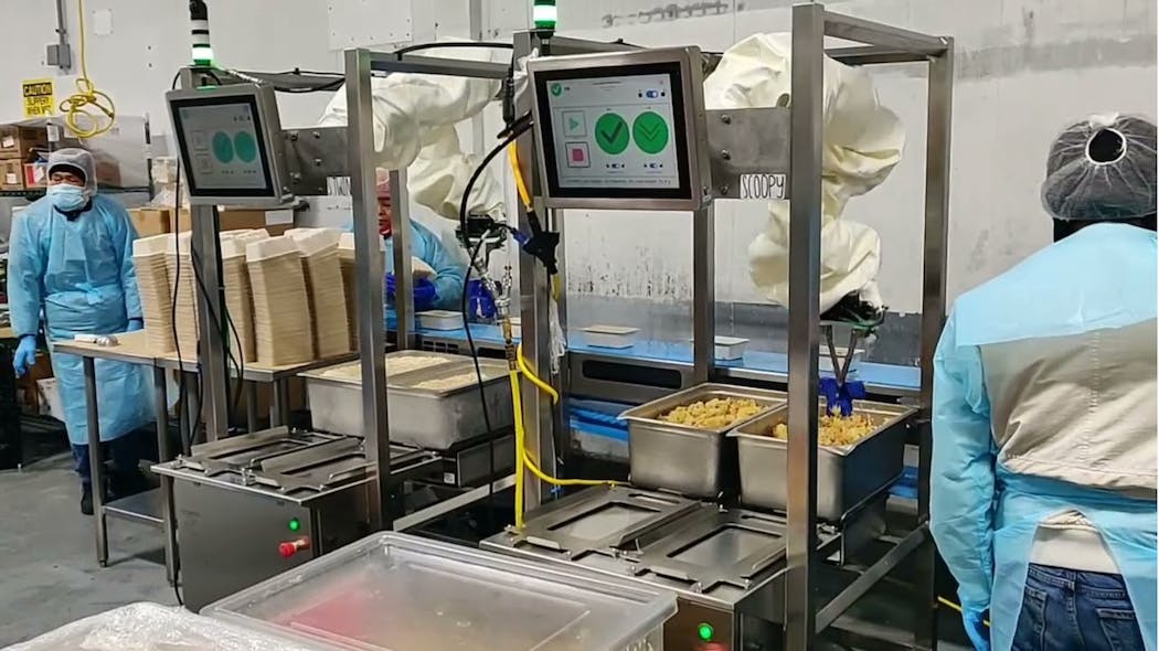 Two Chef system robots operate next to each other in this food tray assembly area at Sunbasket.