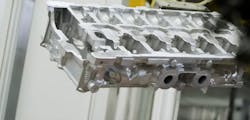 An aluminum power train component following removal from the sand core mold.