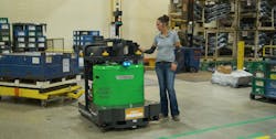 A warehouse employee programs a Vecna Robotics ATG Autonomous Tugger for its next task on the shop floor. Source: Vecna Robotics A warehouse employee programs a Vecna Robotics ATG Autonomous Tugger for its next task on the shop floor. Source: Vecna Robotics