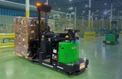 A Vecna Robotics AFL Autonomous Forklift works alongside another robot, moving goods stacked on a pallet in a warehouse distribution center. Source: Vecna Robotics.