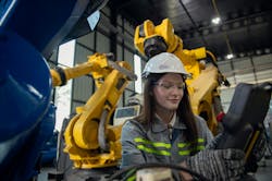 Engineer reviewing robotic workcell Engineer reviewing robotic workcell