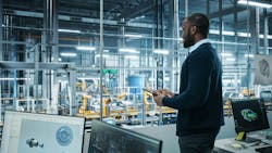 Engineer using AI at manufacturing facility Engineer using AI at manufacturing facility