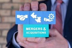 Businessman holding blocks with icons sees text: MERGERS AND ACQUISITIONS Businessman holding blocks with icons sees text: MERGERS AND ACQUISITIONS