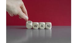 Hand turned a dice and form the expression SD WAN. Symbol for Software defined Wide Area Networking. Hand turned a dice and form the expression SD WAN. Symbol for Software defined Wide Area Networking.