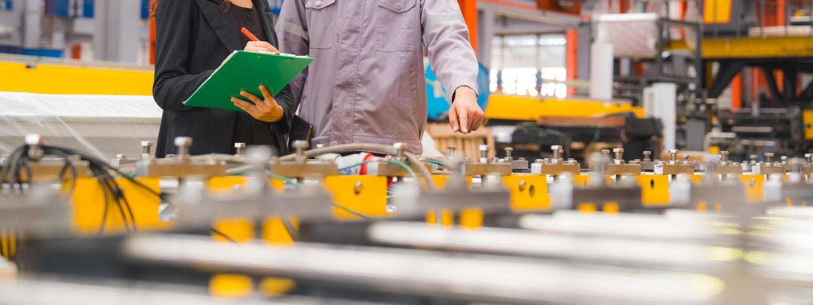 A male expertise engineering is explaining about the quality of metal sheet machine of industry to female inspector and Mechanic or technician in manufacturing or factory, Business's safety check.
