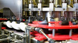 Oil dispensed on a motion controlled fill line into quart bottles at a lubricant manufacturing facility. Oil dispensed on a motion controlled fill line into quart bottles at a lubricant manufacturing facility.