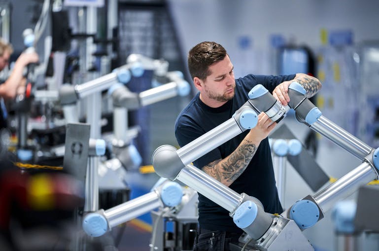 Teradyne Robotics' worker assembling a Universal Robot's cobot.