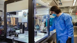 lab technician working with Opentrons system. lab technician working with Opentrons system.